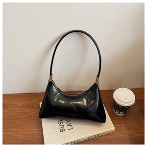 Glossy black crescent shoulder bag featuring gold-toned metal hardware and sleek patent leather