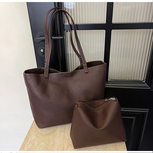 Close-up of deep brown litchi pattern leather tote bag with matching zippered pouch