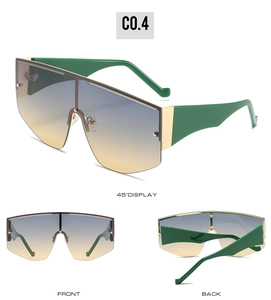 Detail view of oversized sunglasses with gradient lenses and vibrant green temples