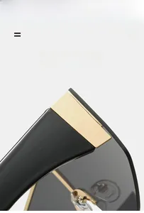 Macro detail of oversized sunglasses featuring black glossy temples and gold metal hinges