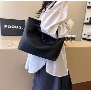 Close-up of black leather tote bag showing high-quality texture and minimalist design