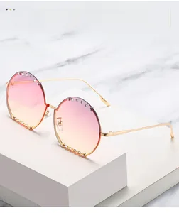 Vue détaillée de lunettes de soleil rondes oversize avec strass et verres dégradés