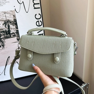 Minimalist mint green crossbody messenger bag with woven texture and top leather handle