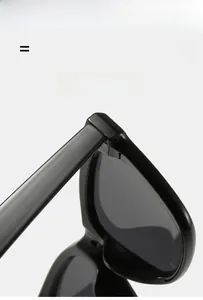 Detail view of high-quality flexible hinge and glossy black frame on small square sunglasses