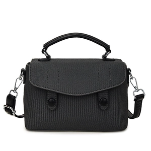 Charcoal grey woven crossbody handbag with black leather handles and silver hardware