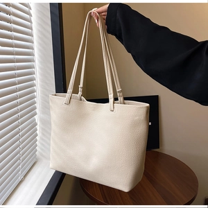Detail of off-white large capacity tote bag with premium lychee grain leather texture