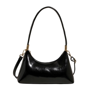 Minimalist black glossy hobo shoulder bag with crescent shape and gold hardware