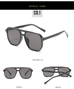 Detail view of vintage double-bridge sunglasses with black frame and golden rivets