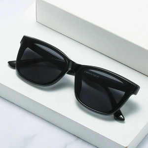 Fashion small square frame sunglasses with black polarized lenses on a white display
