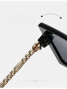 Detail of durable gold metal chain temple and reinforced hinge on oversized sunglasses