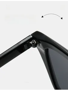 Macro detail of a durable metal hinge on black square sunglasses with cross screws