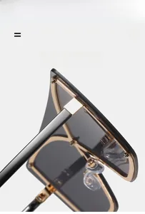 Detail of high-elasticity golden metal hinges on oversized flat top fashion sunglasses
