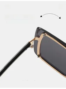 Detail of durable gold metal hinges and black temples on oversized fashion sunglasses