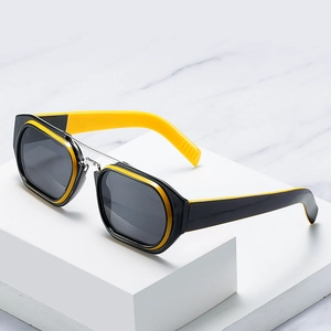 Sporty square double-bridge sunglasses with black and yellow frame on marble surface