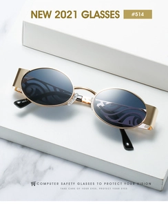 Detailed macro view of gold metal frame sunglasses with flame pattern on dark lenses