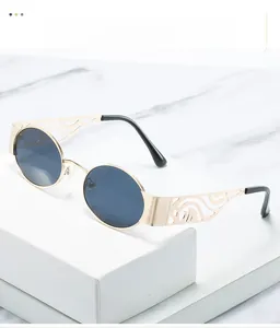 Detailed view of golden metal sunglasses temples with intricate hollow wavy patterns
