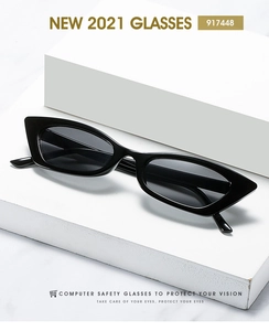 Detail shot of black cat-eye sunglasses on minimalist white geometric display blocks