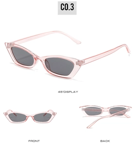 Detail view of pink jelly cat-eye sunglasses with retro narrow frame and dark lenses