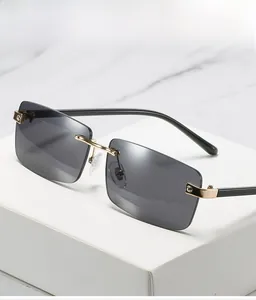 Macro view of square rimless gradient sunglasses with gold metal bridge and hinges