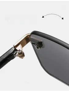 Detail of durable gold metal hinge and black temples on rimless square sunglasses