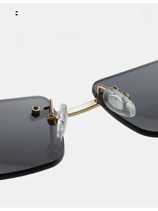 Macro shot of gold metal bridge and soft silicone nose pads on rimless sunglasses
