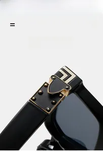 Close-up of golden metal rivets and arrow hinge detail on black sunglasses frame
