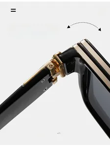 Close-up of durable gold metal hinge on premium black oversized sunglasses