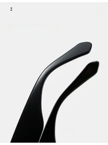 Detail view of ergonomic curved matte black temples on stylish fashion sunglasses