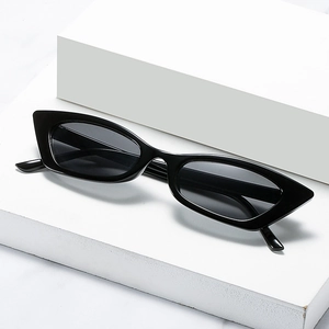 Chic black cat eye sunglasses for women with retro small frames on a marble display