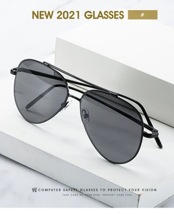 Close-up of retro metal double bridge aviator sunglasses on minimalist stone base