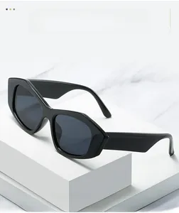Close-up of thick black geometric frame sunglasses on white textured pedestal