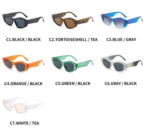 Flat lay of trendy cat eye sunglasses in black, tortoise, blue, and assorted colors