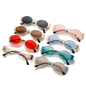 Retro oval sunglasses with wide metal temples and decorative laser-cut lenses in multiple colors