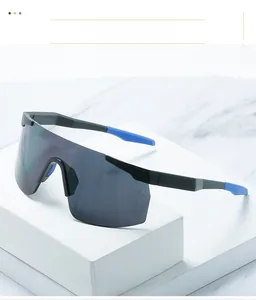 Detail of sports sunglasses with large grey lens and blue anti-slip temple tips