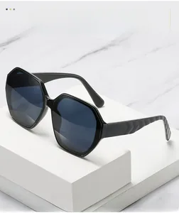 Detail shot of black irregular polygon sunglasses featuring unique wavy temple design
