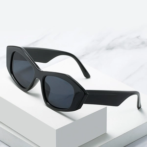 Trendy black geometric cat-eye sunglasses with thick frame and dark grey lenses for women