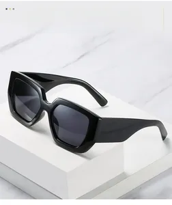 Close-up of modern black thick-frame sunglasses on geometric stand with sharp lighting