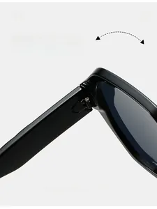 Detailed macro view of the durable hinge and printed specifications on black square sunglasses