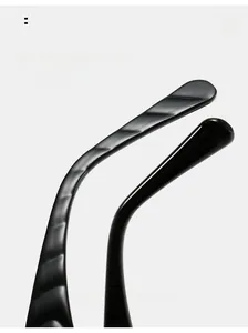 Detail view of ergonomic curved wavy legs on irregular black sunglasses for comfort
