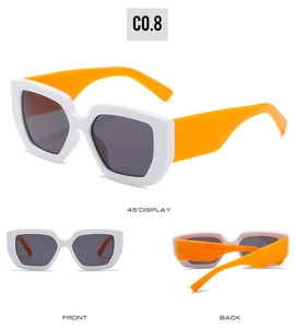Macro view of white square sunglasses with orange temples and dark grey tinted lenses