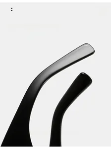 Close-up of black retro sunglasses showing curved mirror legs for comfortable wear