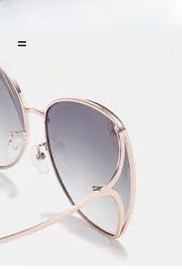 Detail of rose gold metal frame sunglasses featuring purple gradient lenses and nose pads