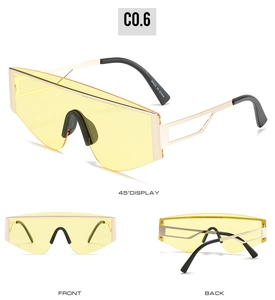 Detail view of yellow oversized fashion sunglasses with gold metal frame and side temple