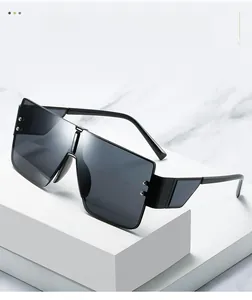 Detail of grey square sunglasses lenses with silver rivets on a white marble surface