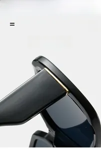 Detail of square black glossy sunglasses frame corner with durable gold metal hinge