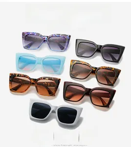 Flat lay of cat eye sunglasses in various gradient colors including floral and tortoise