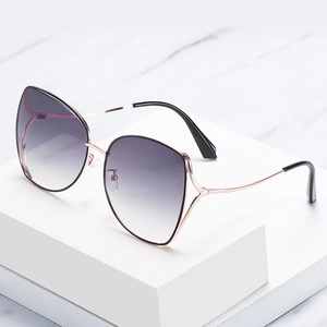 Elegant rose gold polygon sunglasses for women with purple gradient lenses on white marble
