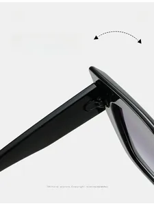 Detailed macro view of durable metal hinges and printed specs on black cat eye sunglasses