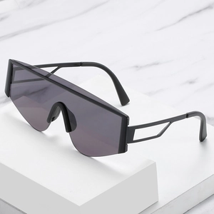 Fashion oversized shield sunglasses with futuristic cutout temples on marble display