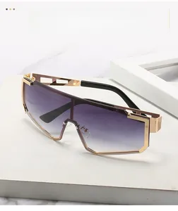Macro shot of purple gradient lens and gold geometric hollow metal temples on sunglasses